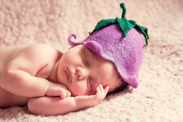 baby with eggplant hat