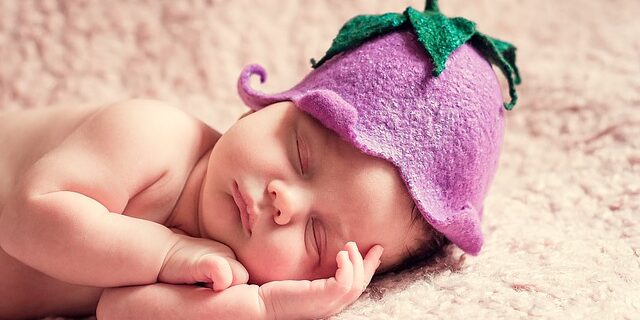 baby with eggplant hat